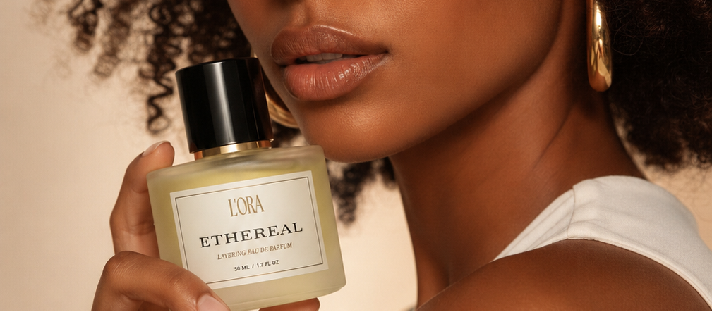 Model holding ETHEREAL by L'ORA against warm skin — a fragrance designed to enhance your aura
